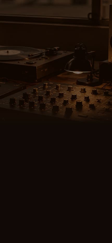 A studio desk with mixing equipment and speakers